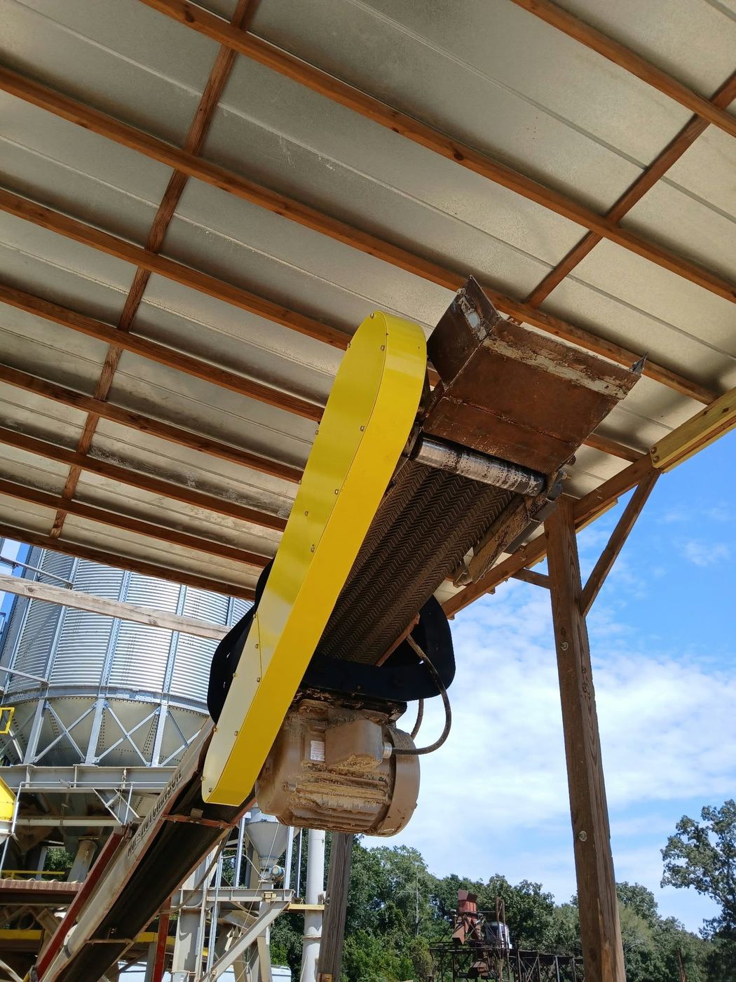 The finished yellow belt guard installed on the underside of the conveyor.