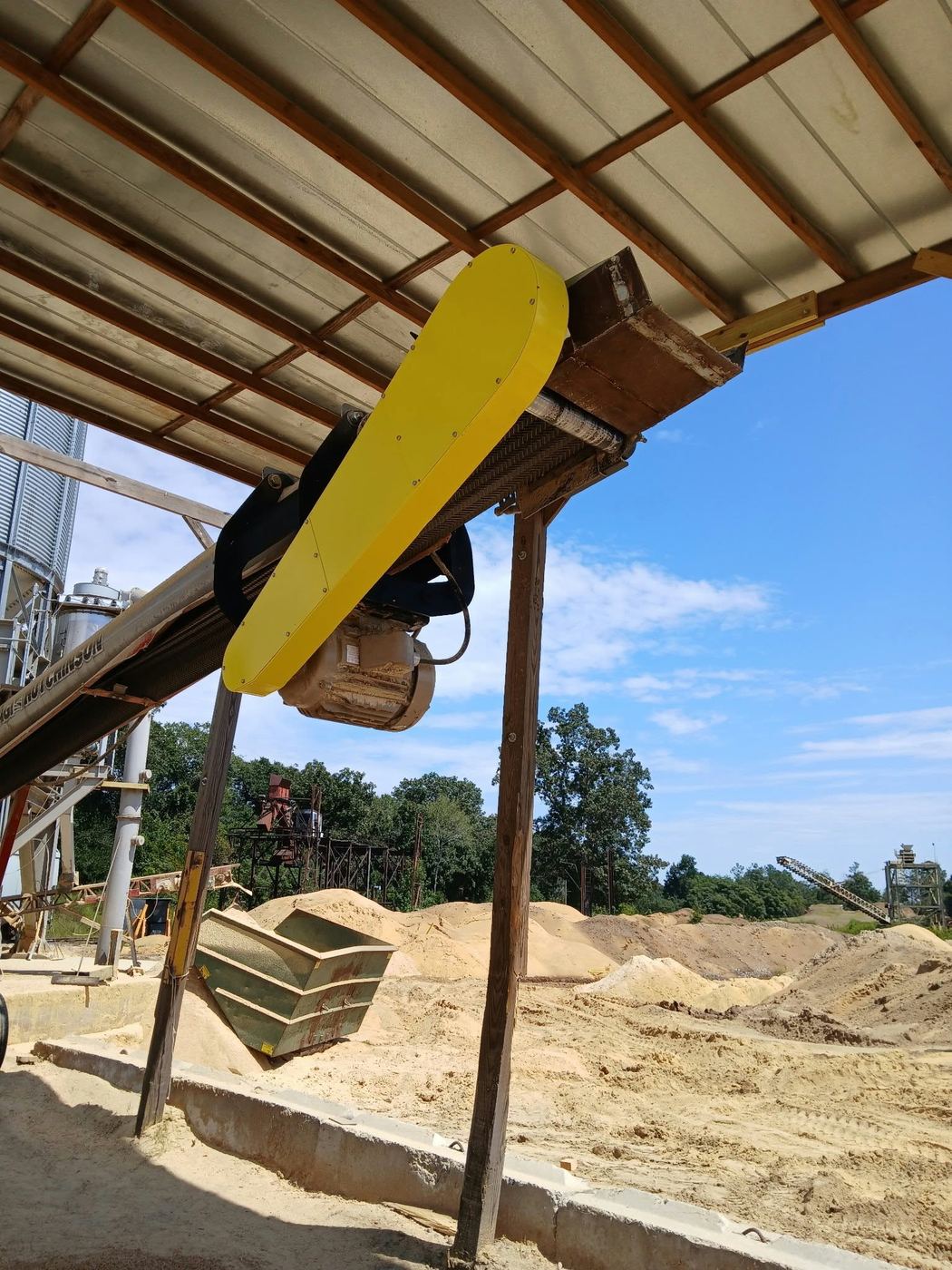 The finished yellow belt guard installed on the conveyor at the pellet plant.