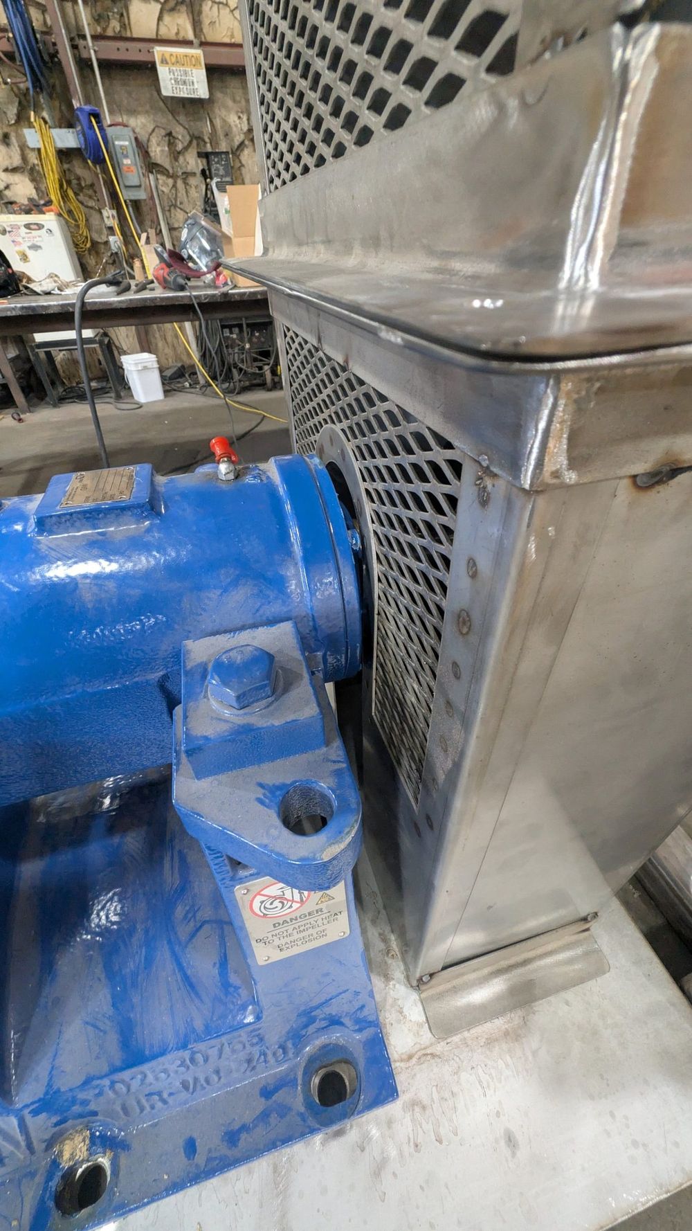 Close view of the expanded metal panel on the side of the guard beside the pump bearing housing.