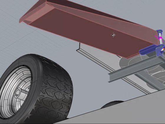 3D model of a folded stainless chute mounted to the frame of a trailered machine.