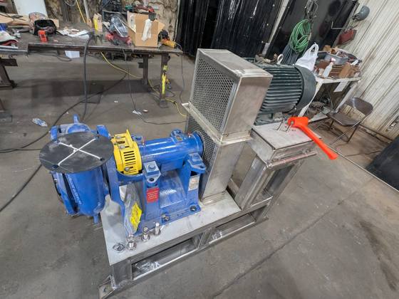 Stainless pump stand with the pump on a low deck and the motor raised behind it.